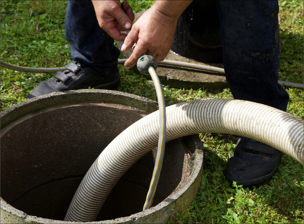 a contractor checking and pumping a septic tank OPT